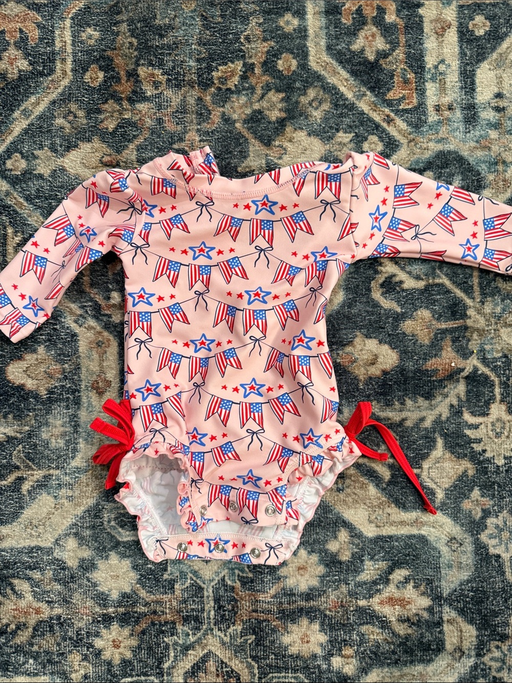 Ruffle Butts Pink Long-Sleeve One-Piece Swimsuit with Red and Blue Stars & Flags
